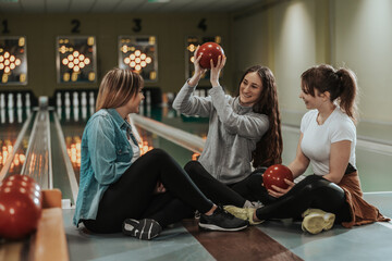 A Three Female Friends Having Fun In A Bowling Alley