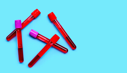 Blood in test tubes on blue background.