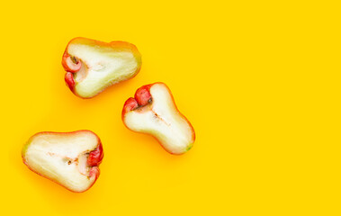 Fresh rose apple on yellow background.