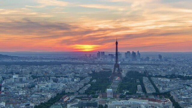 Panorama of Paris at sunset timelapse. Eiffel tower aerial view from observation deck of montparnasse building in Paris - France. Colorful sky at summer day