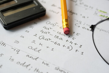 Hand writing algebra equations on a paper 