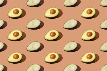 Avocado on brown cream background. Pattern.