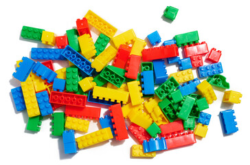 Multi-colored plastic cubes of a children's designer on a white isolated background, top view