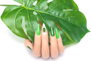 Female hand with stiletto nail design. Glitter green nail polish manicure. Female model hand with...
