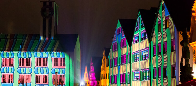 City event where the facades of the houses are illuminated with different colors and patterns