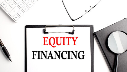 EQUITY FINANCING text written on paper clipboard with office tools