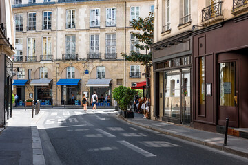 Cozy street with tables of cafe  in Paris, France. Cityscape of Paris. Architecture and landmarks of Paris