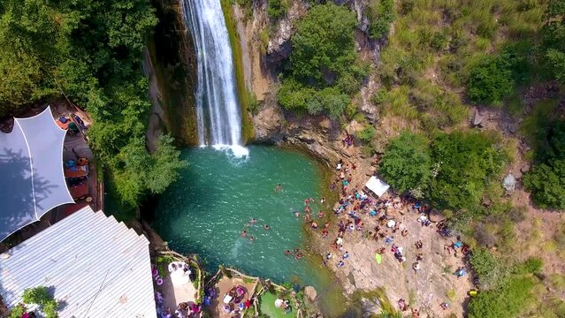 kefrida waterfalls with people swimming