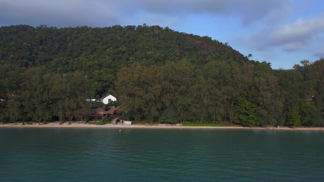 Mountainous island with conifers on beach. Fantastic aerial view flight 
Klong Prao Beach, koh chang island thailand 2022. boom sliding to right drone
4k uhd cinematic footage.