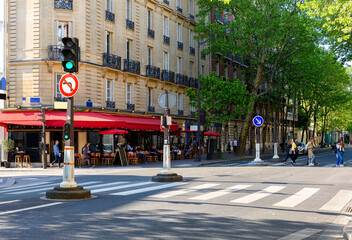 Cozy street with tables of cafe  in Paris, France. Cityscape of Paris. Architecture and landmarks...