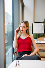 Teen talking on mobile phone in a bar