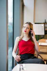 Fototapeta premium Teen talking on mobile phone in a bar