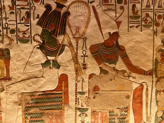 The colorful designs in Queen Nefertari tomb in Queens valley in Luxor - Osiris and Atum receiving...