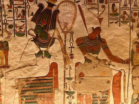 The colorful designs in Queen Nefertari tomb in Queens valley in Luxor - Osiris and Atum receiving offerings from Nefertari