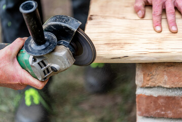 A carpenter works in a garden.