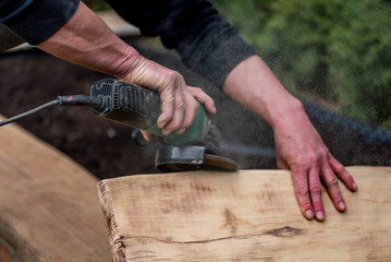 A carpenter works in a garden.