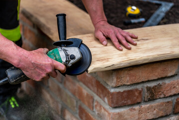 A carpenter works in a garden.