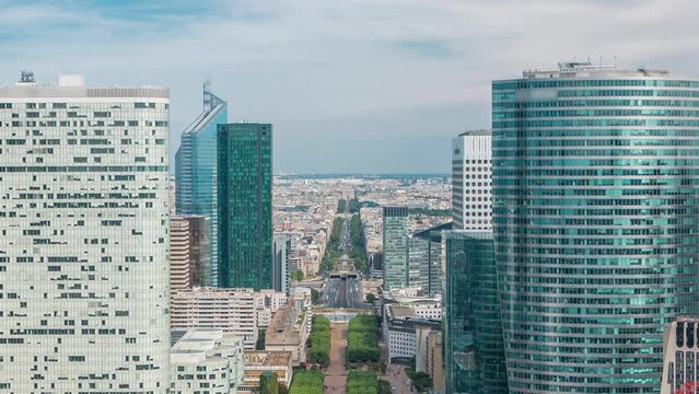 Aerial view of Paris to triumphal arch and modern towers timelapse from the top of the skyscrapers in Paris business district La Defense. Sunny summer day with blue cloudy sky. Paris, France