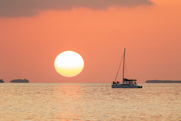 sunset on the sea from a catamaran style tourist boat.