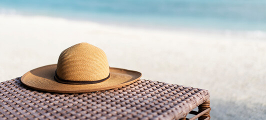 Fototapeta na wymiar Straw hat and sunglasses on the beach. Beach holiday concept