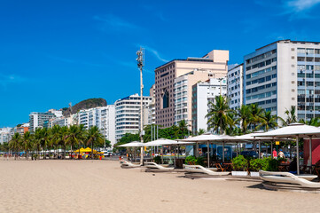 Fototapeta na wymiar Kiosks on Copacabana beach in Rio de Janeiro, Brazil. Copacabana beach is the most famous beach in Rio de Janeiro. Sunny cityscape of Rio de Janeiro