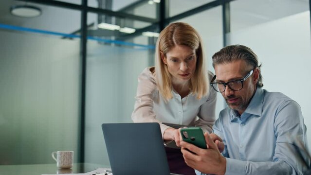 Two employees working together office closeup. Business people discussing work