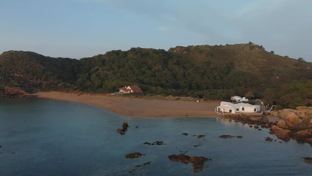 Mountain background in Menorca Spain with huge rocks in the shallow bay.