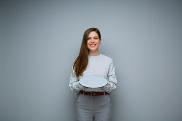 Happy woman holding empty gray plate. Isolated female portrait.