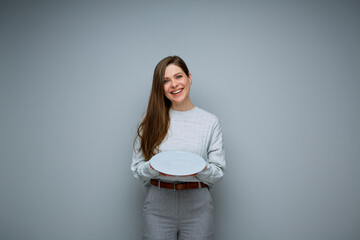 Happy woman holding empty gray plate. Isolated female portrait.