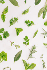 Variety of fresh herbs isolated on background, top view.