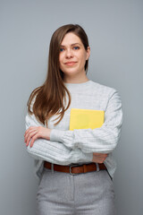 Fototapeta premium Young accountant woman holding yellow book. Isolated portrait.