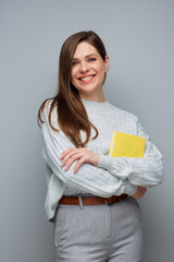 Young accountant woman holding yellow book. Isolated portrait.