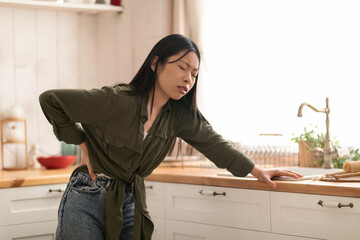 Sick asian woman suffering from pain on lower righ side