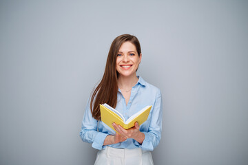 Smiling teacher or student woman holding open book. Isolated female portrait. - 585960870
