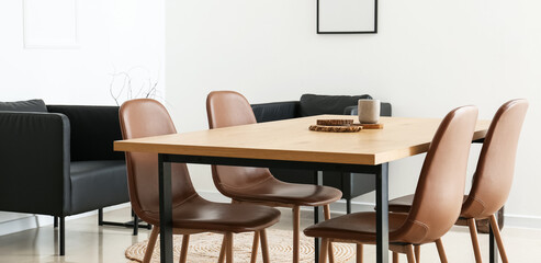 Interior of modern dining room with wooden table and brown chairs