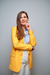 Woman in yellow jacket looking away. Isolated female portrait.