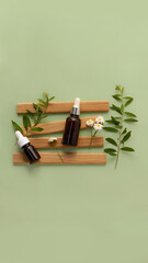 two bottles for cosmetics made of dark glass lie on wooden stand surrounded by branches of plant. green background, soft shades. billet for designers and advertising your product 