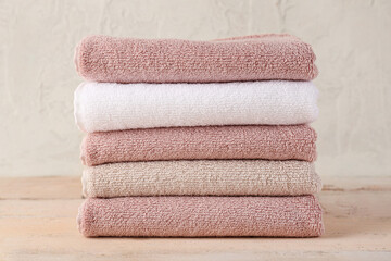Stack of folded soft towels on wooden table