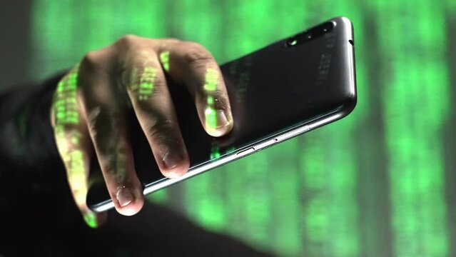 Vertical closeup of green code text rolling over smartphone in hand