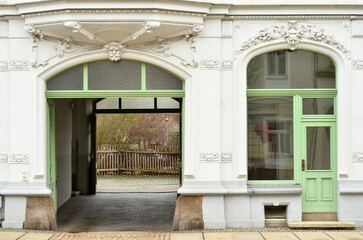 View of old building with wooden door and archway