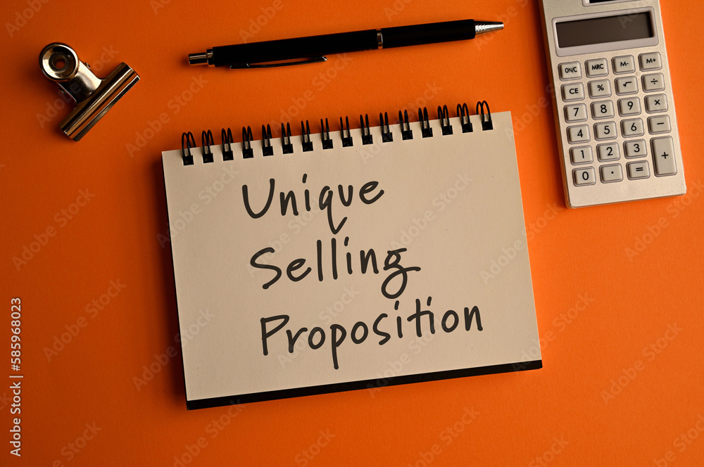 Poster there is a notebook with the word unique selling proposition. it is eye-catching image.