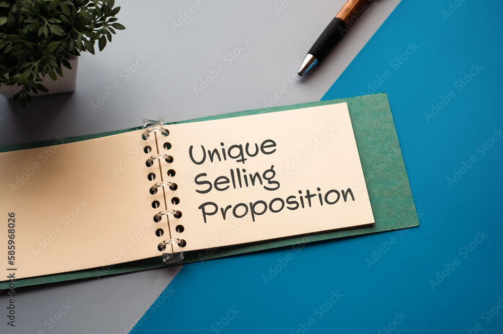 Poster there is a notebook with the word unique selling proposition. it is eye-catching image.