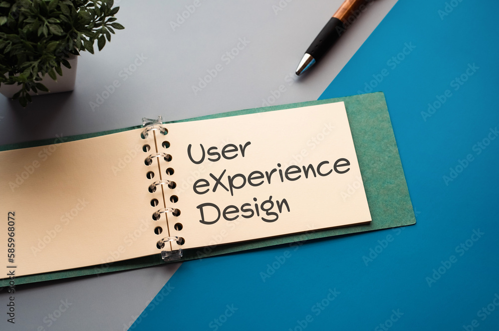 Poster there is a notebook with the word user experience design. it is eye-catching image.