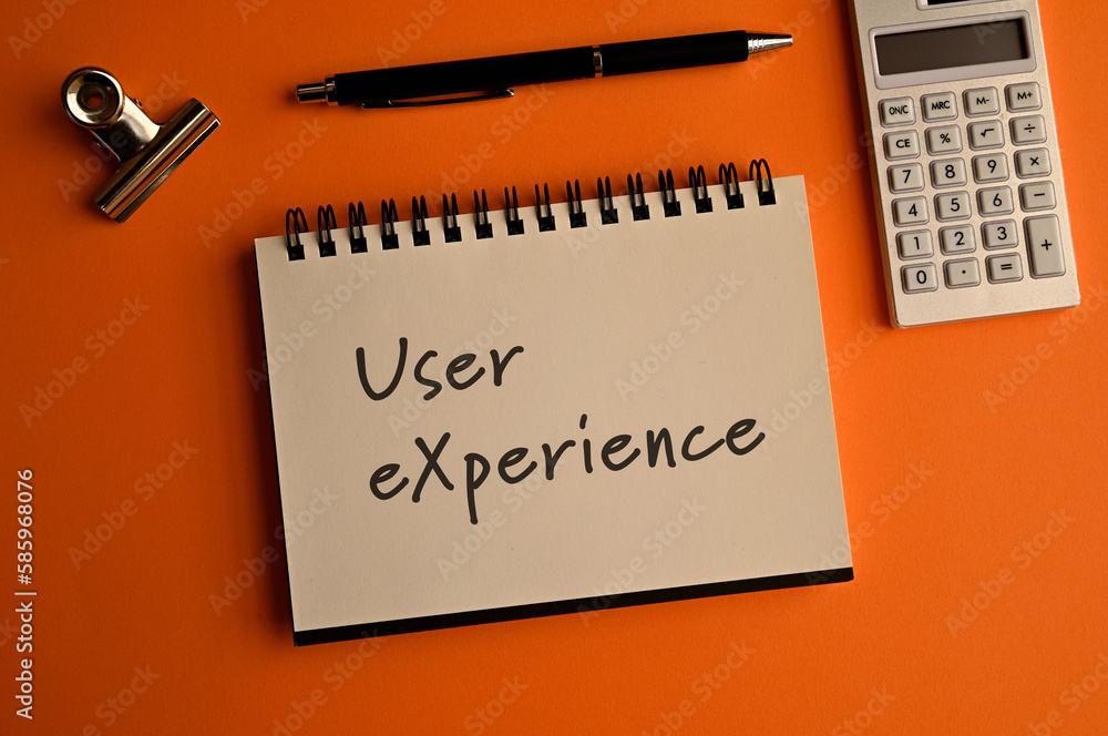 Poster there is a notebook with the word user experience. it is eye-catching image.