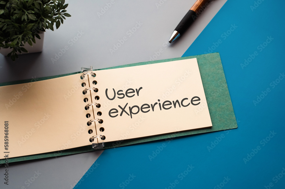 Poster there is a notebook with the word user experience. it is eye-catching image.