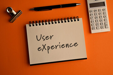 There is a notebook with the word User eXperience. It is eye-catching image.