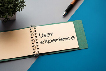 There is a notebook with the word User eXperience. It is eye-catching image.