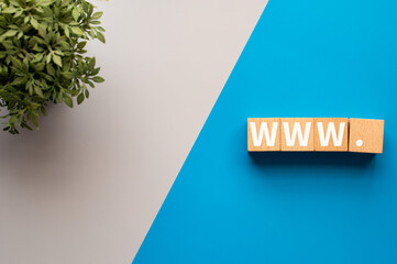 There is wood cube with the word WWW.It is an abbreviation for World Wide Web as eye-catching image.