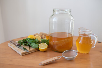 Homemade fermented kombucha tea in a glass jar, lemon and mint flavoured Kombucha healthy drink, organic probiotic beverage