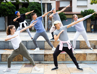 Fototapeta na wymiar Portrait of group of teenagers at city street. Hip hop dancers